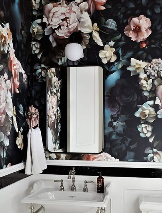 Powder room with floral wallpaper, sink, and mirror.