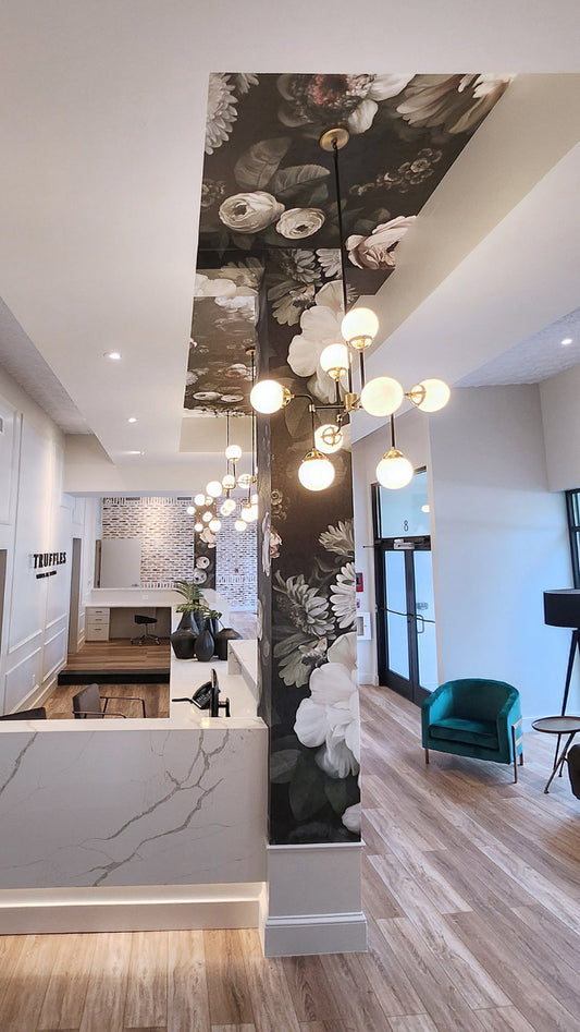 Black Floral Wallpaper in modern interior with chandelier, and furniture.