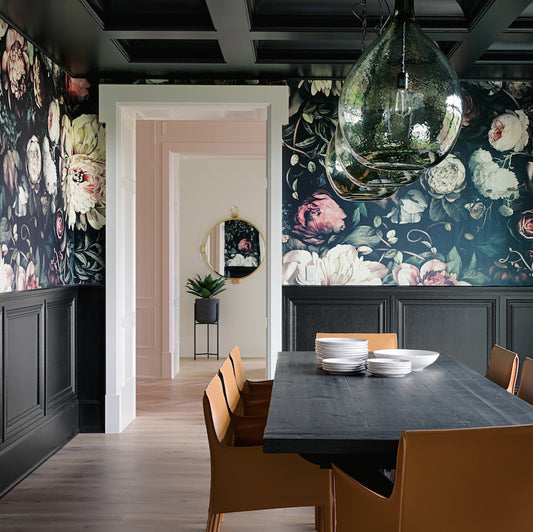 Dining room with Ellie Cashman's Dark Floral II Wallpaper with dark wooden table, and chairs.