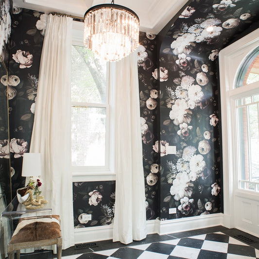 Black floral wallpaper in hallway with white curtains, and a checkered floor.