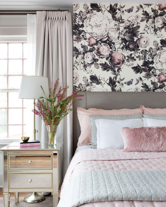 Floral wallpaper by Ellie Cashman above a bed with pink and white bedding.